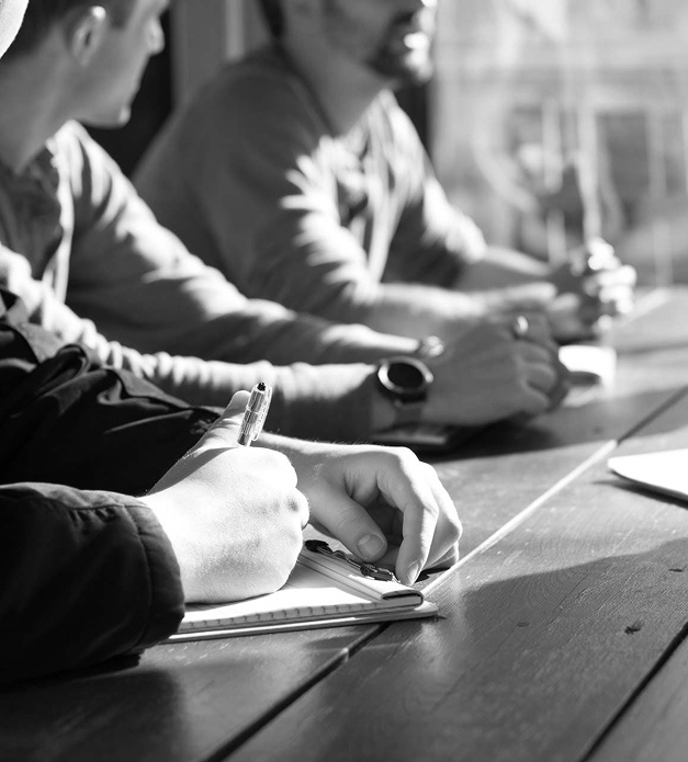 focus on man writing on paper